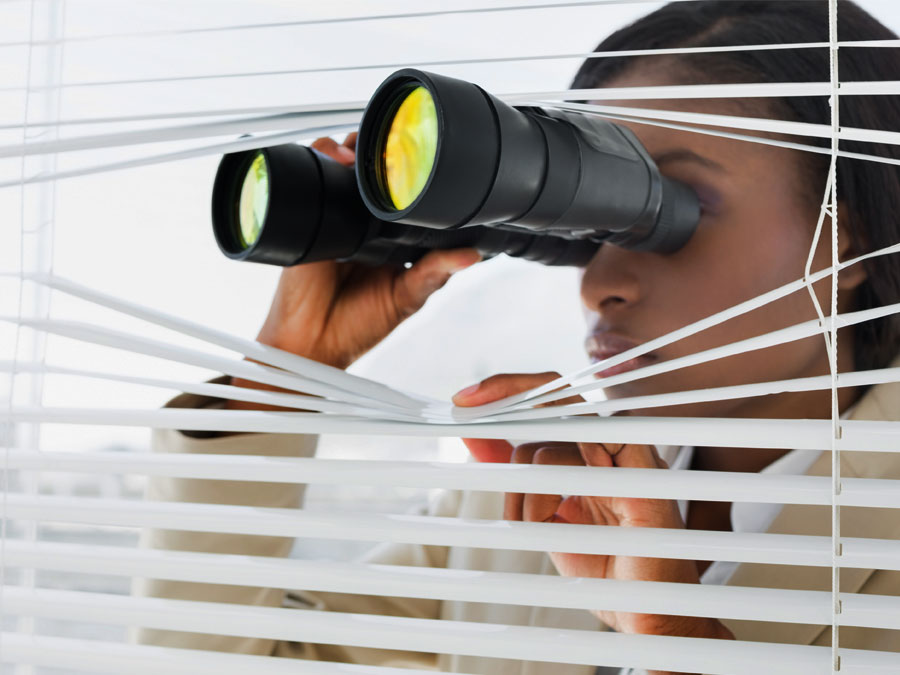 customer attrition customer churn depiction brand executive looking through binoculars office blinds