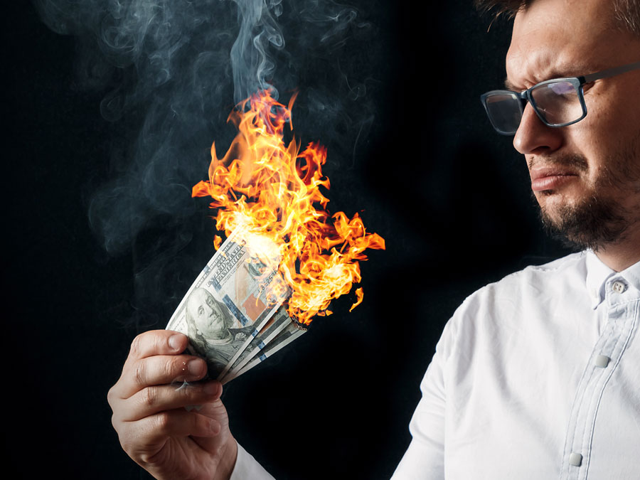 customer attrition depiction businessman burning money