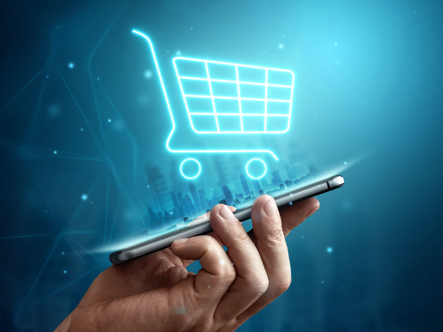 customer experience trends led by ecommerce online shopping retail depiction hand holding phone with glowing shopping cart