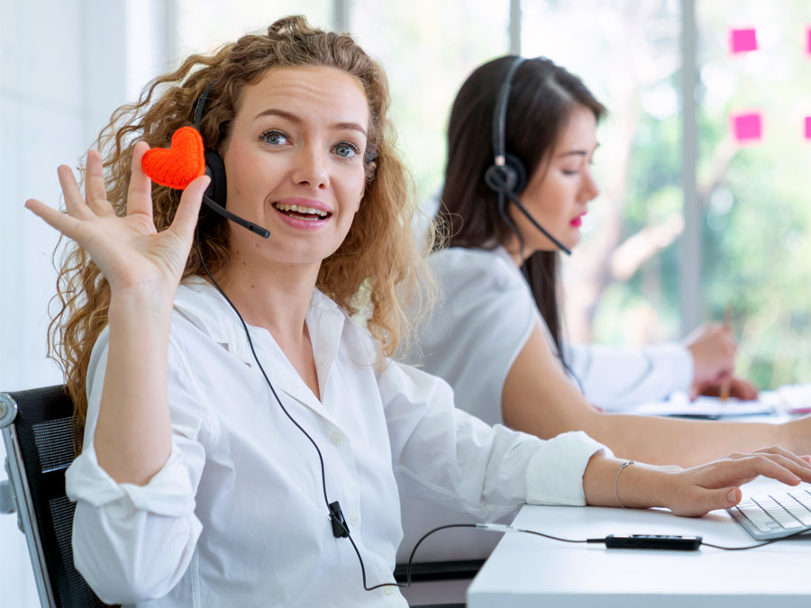 customer satisfaction rep holding hear in call center helping customers over the phone