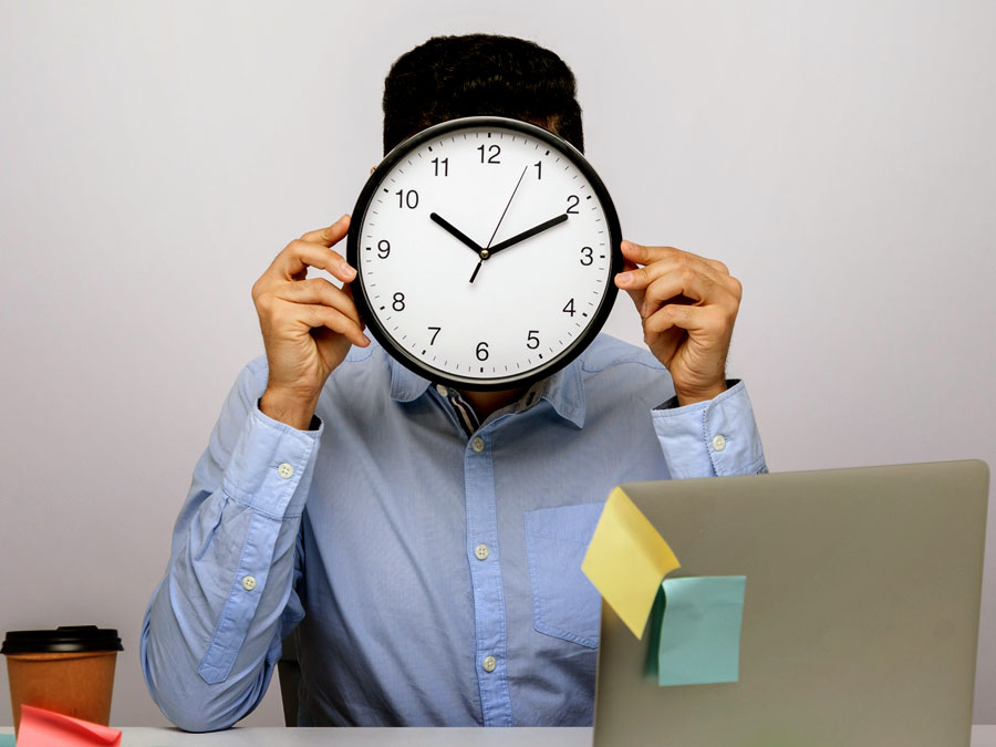 customer service agent covering face with clock in call center office