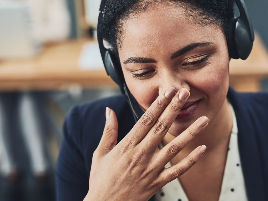 customer service skills depiction rep covering mouth in office