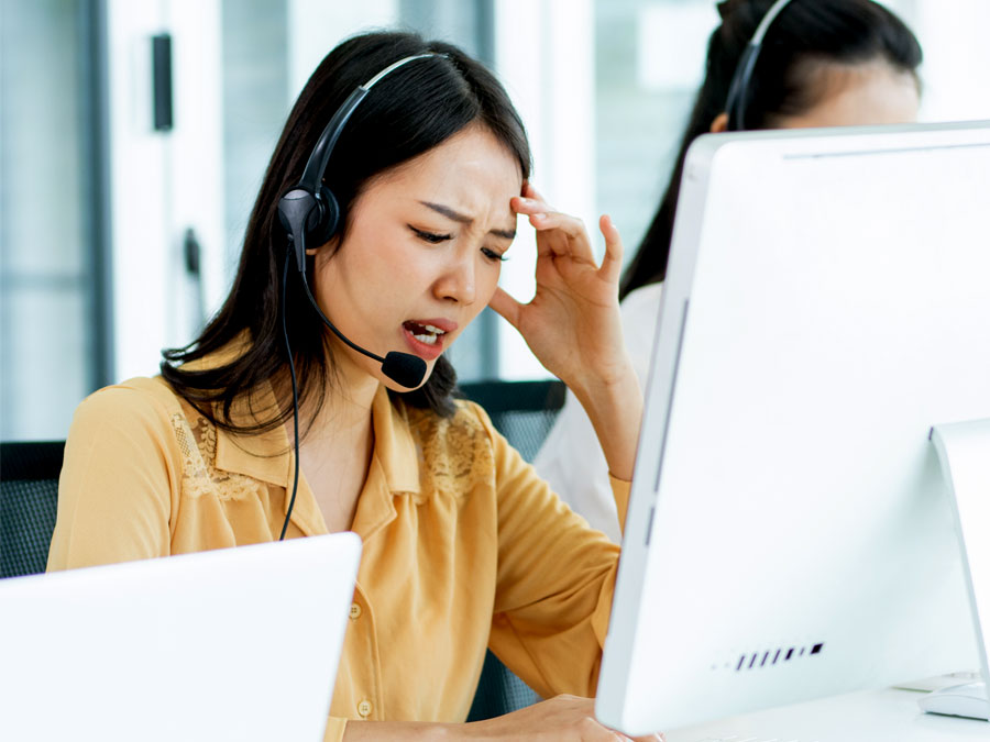 customer service skills depiction stressful work holding head headache