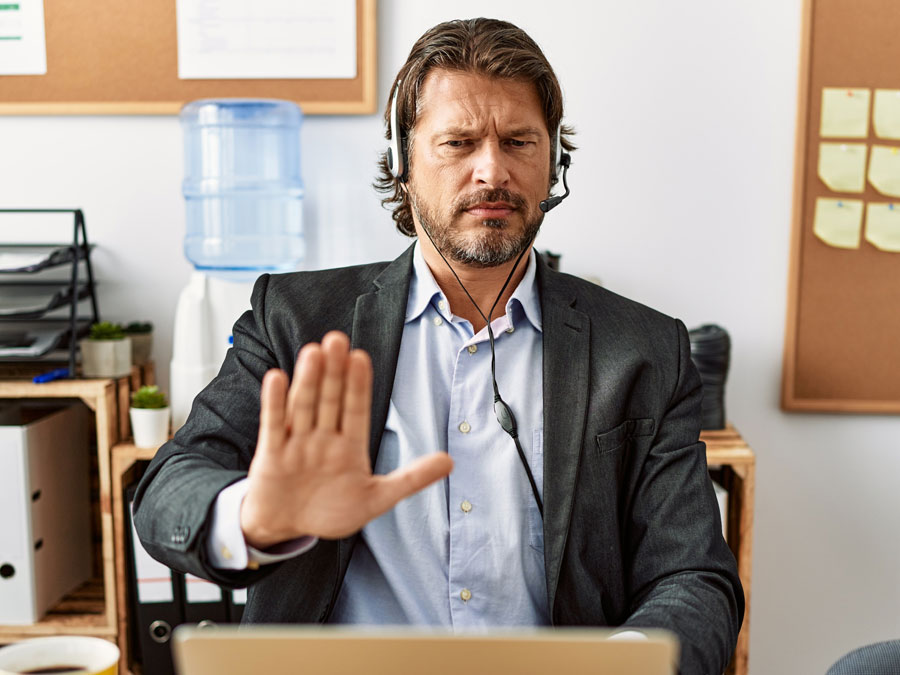 customer service tip serious busy call center agent holding hand to laptop screen