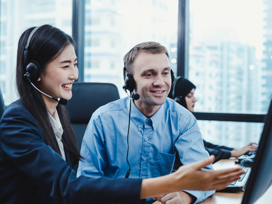 customer support agent receiving feedback from call center team leader