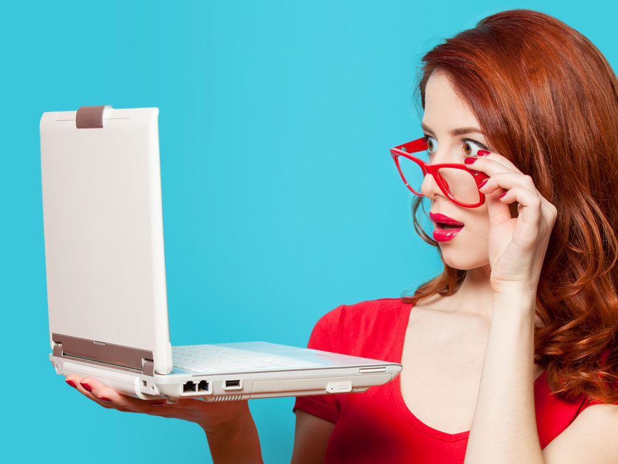 customer support representatives looking at laptop with red glasses