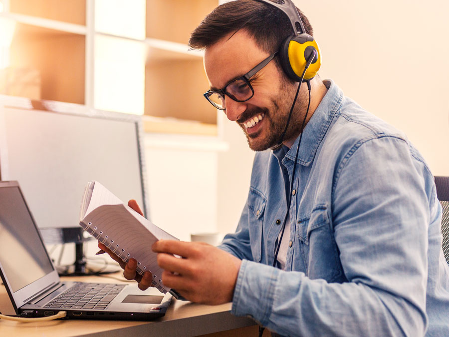 customer support representatives smiling reading in OABPO call center