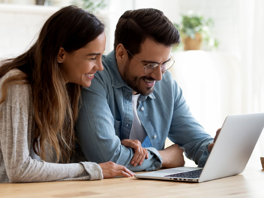 delightful customer experience depiction couple smiling at laptop