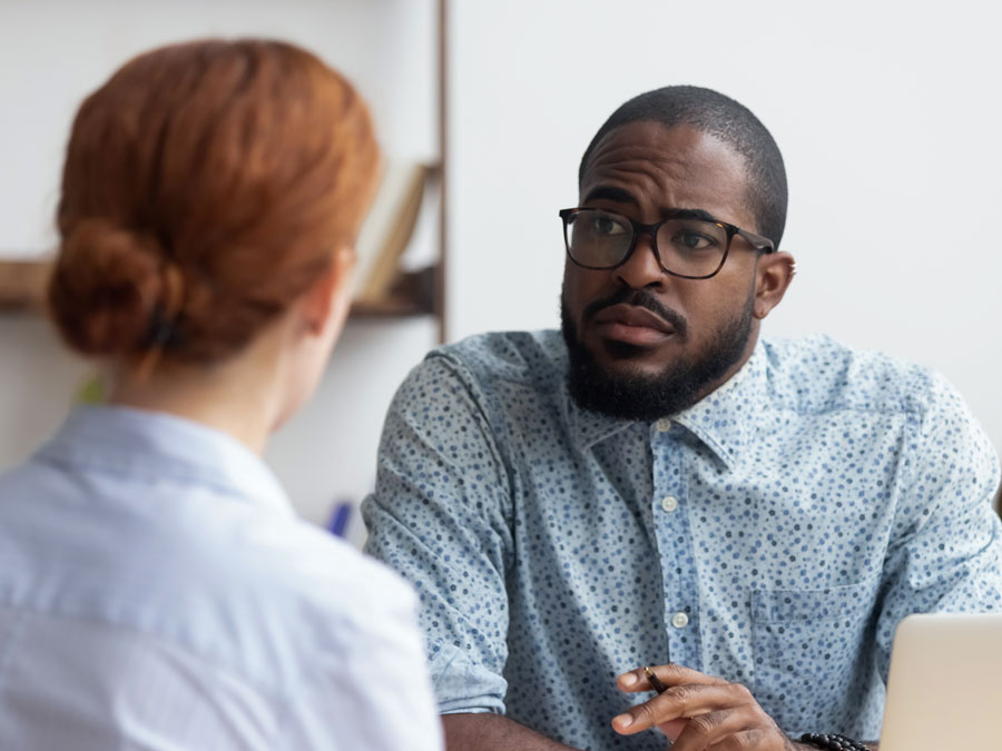 doubtful call center team leaders in meeting with customer service employee