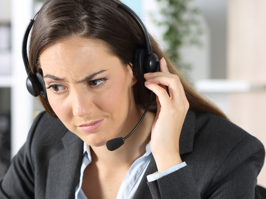 dubious customer service agent looking at agent profile on computer