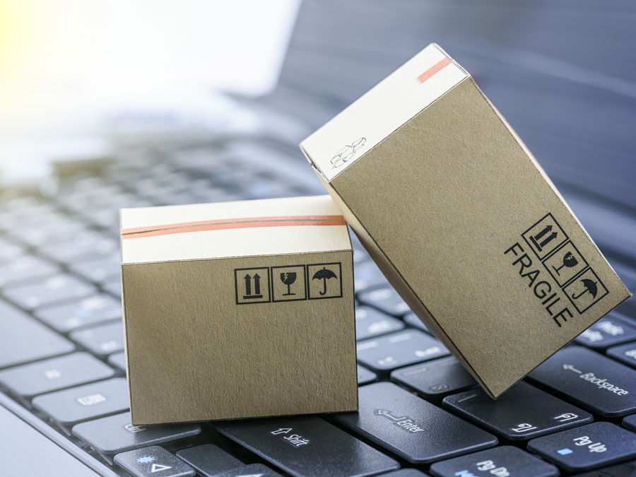 ecommerce fraud depiction online shopping miniature delivery box on laptop