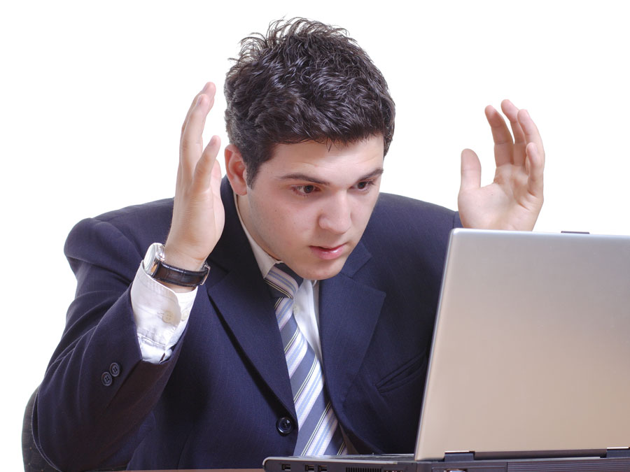 failing customer satisfaction depiction businessman confused lookin at laptop in disbelief