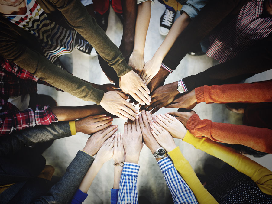 hands of diverse employees from multilingual call centers in the Philippines joining together