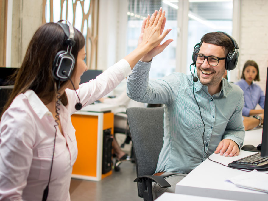 happy contact center reps high five