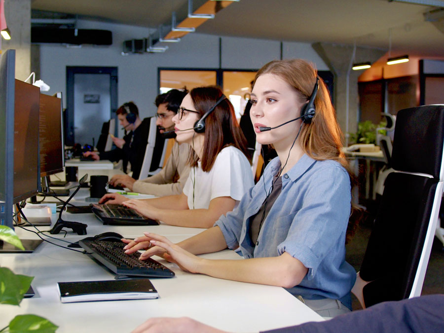 outsourced customer experience team busy assisting customers on the phone