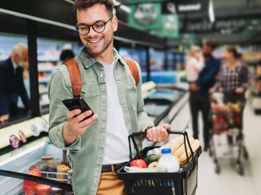 positive customer experience consumer with customer support app on phone in grocery store 