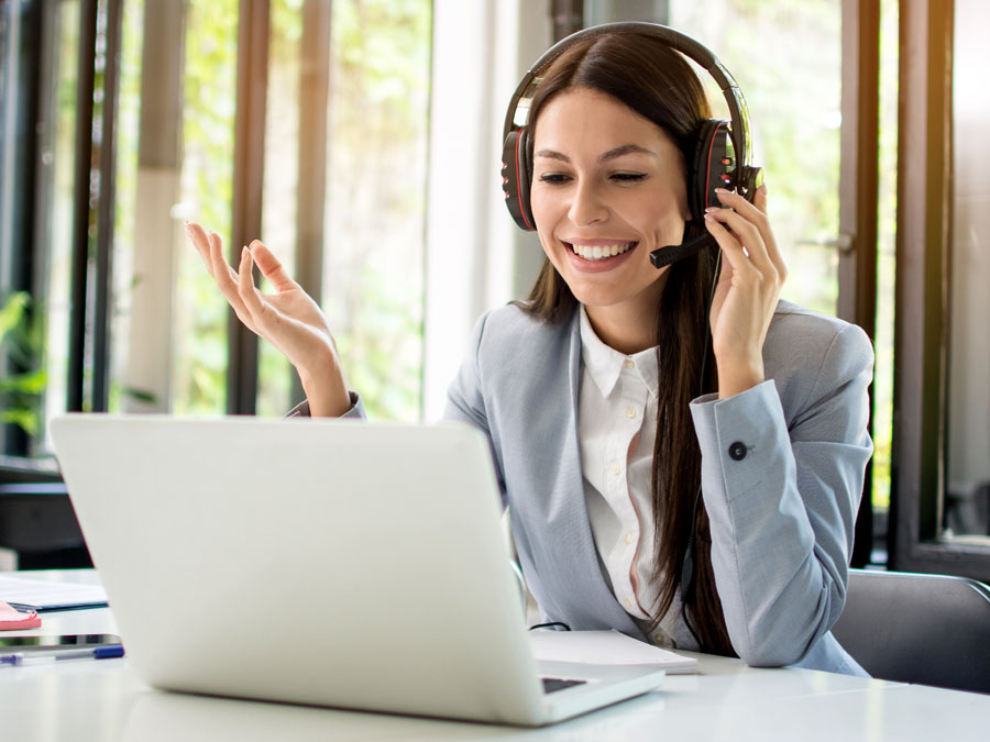 smiling customer experience agent assisting consumer in call center