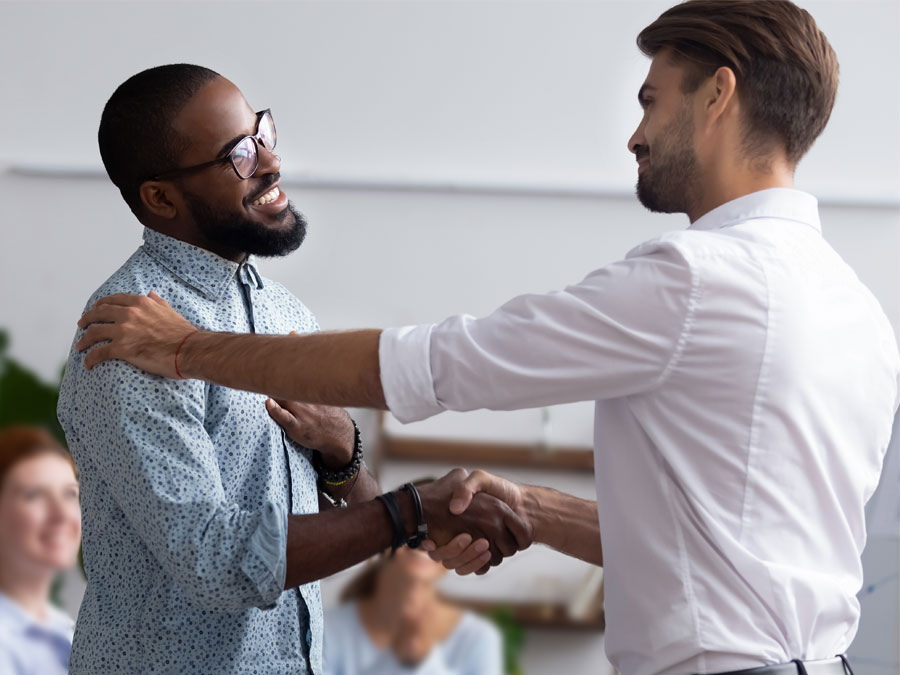 supportive technical support agents shaking hands 