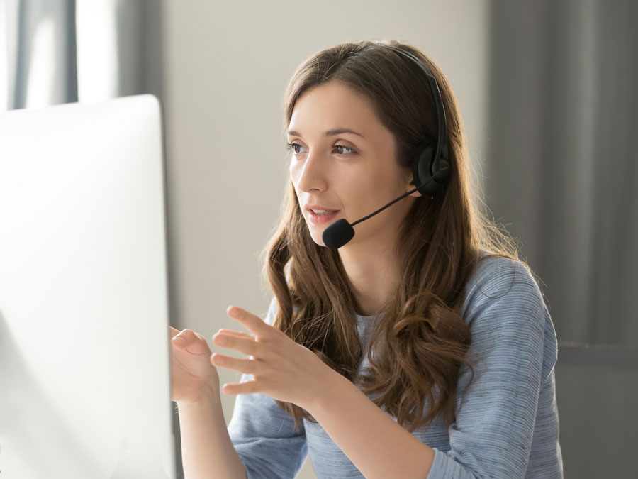 telemarketing agent in front of computer explaining to customer