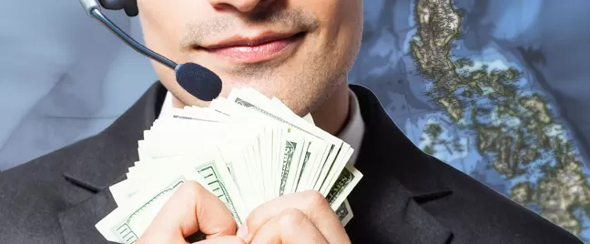male-call-center-agent-holding-dollar-bills