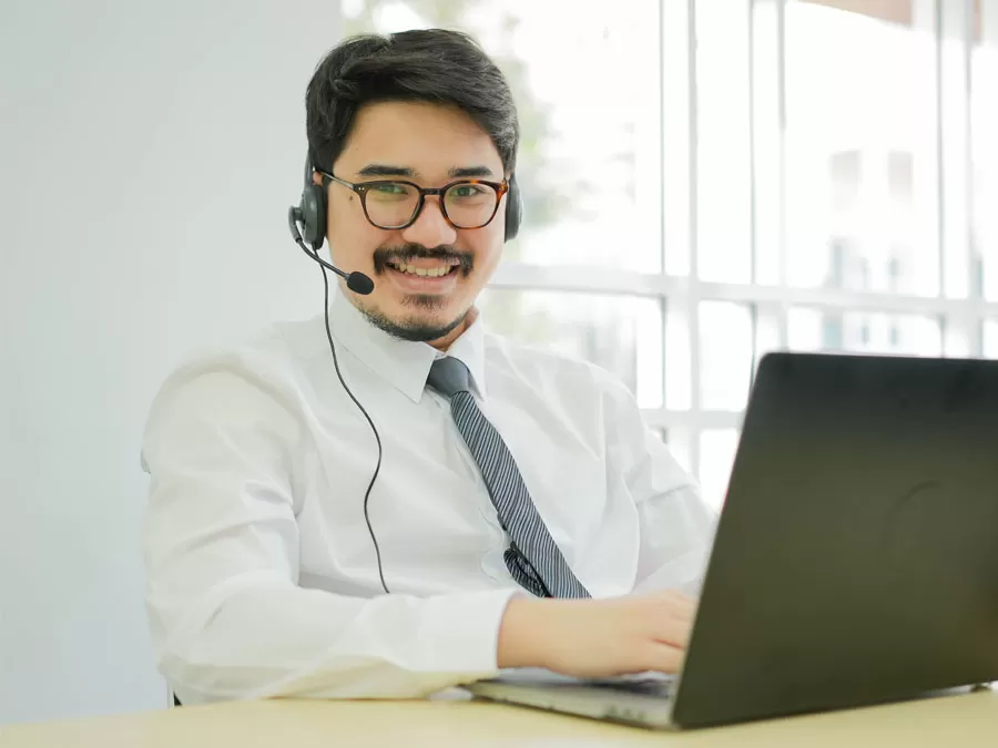 customer service agent talking to customer using laptop