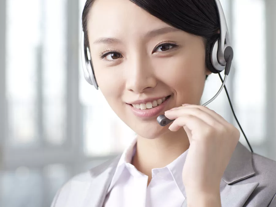 smiling call center agent talking to customer