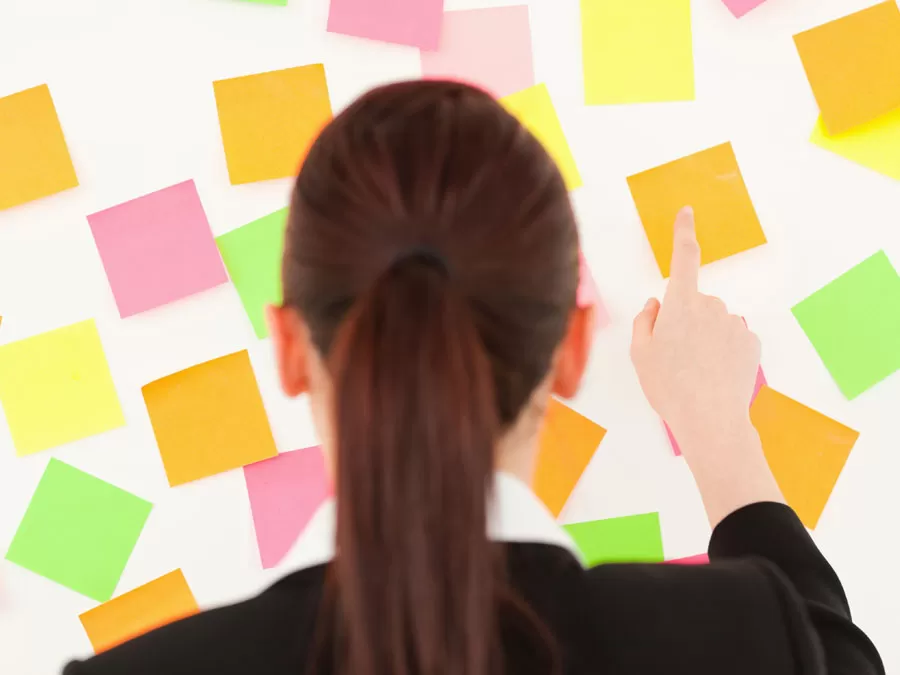 content moderation analyst pointing at post it notes
