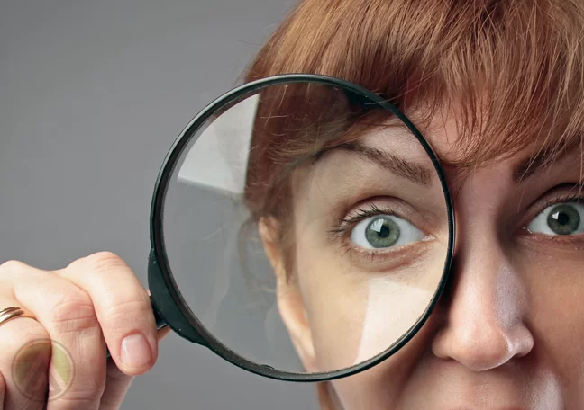 woman-looking-through-magnifying-lens