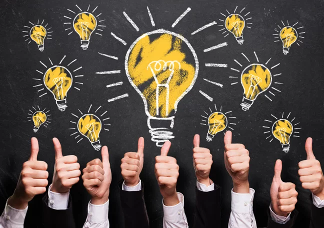 lightbulb-chalk-drawing-thumbs-up-businessmen