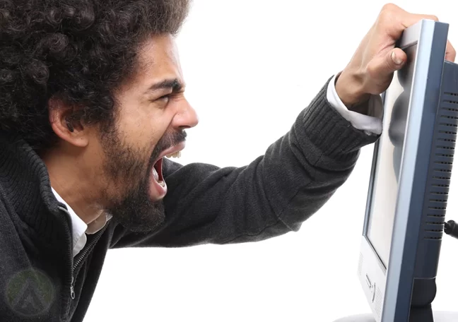 man-with-afro-shouts-at-computer-monitor