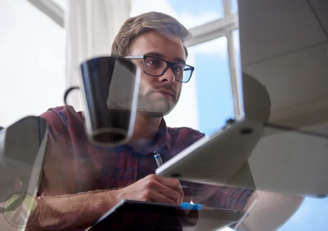 young-male-employee-studying-laptop