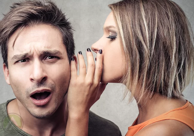 blonde-whispering-something-to-a-shocked-mans-ear