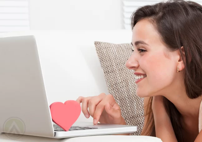 smiling-woman-using-laptop-with-heart