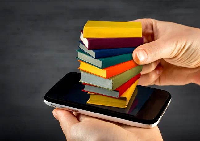tiny books on top of smartphone