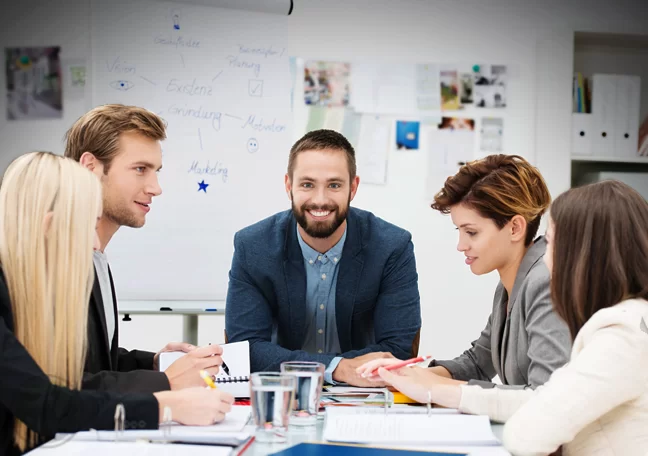 smiling supervisor with business team in meeting