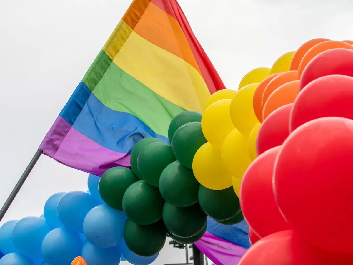 Pride flag with rainbow balloons