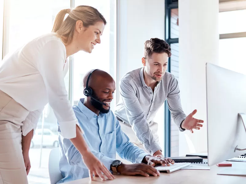 Outsourcing call center manager helping CX customer support agent help customers
