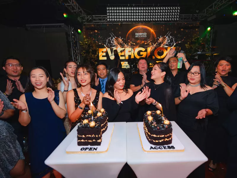 Open Access BPO leadership blew candles on 20 anniversary cake during Makati's Everglow kickoff party