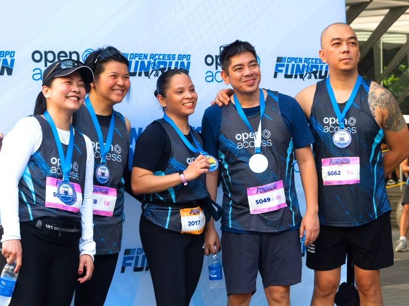 Open Access leaders proudly display their medals after completing the OABPO Fun Run in