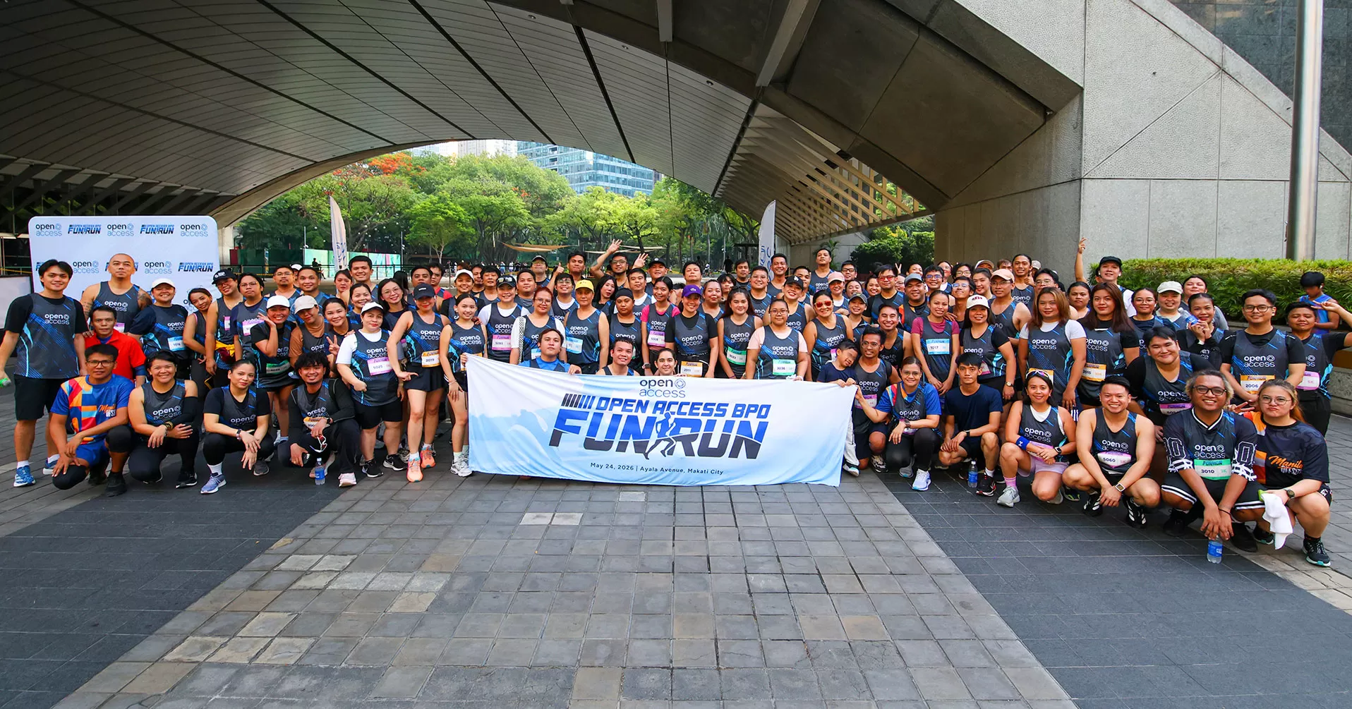 The Open Access BPO crew celebrates crossing the finish line at the Fun Run 2026 in Makati, Philippines
