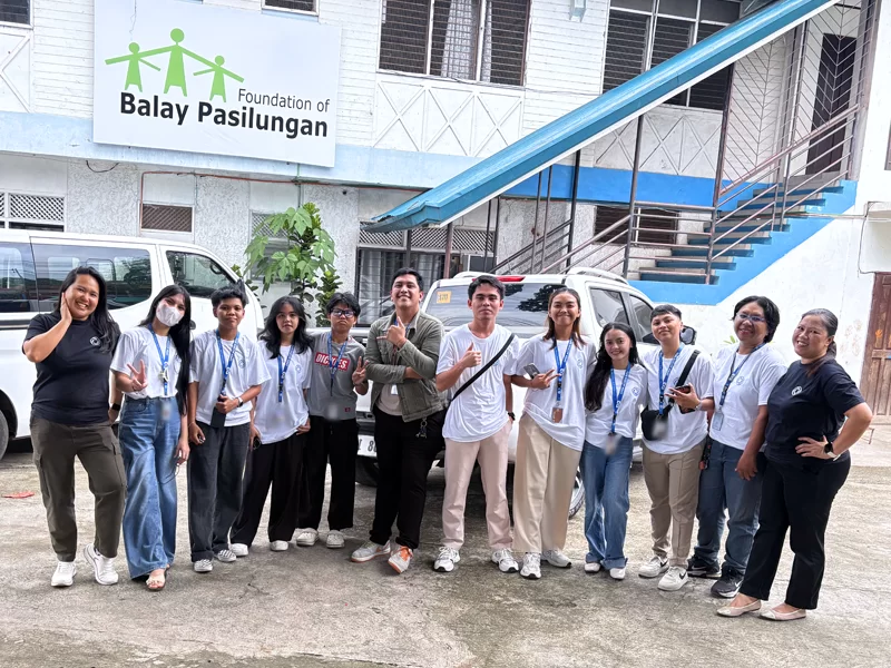 Community outreach programs by Open Access featuring volunteers gathered outside the Balay Pasilungan Foundation before conducting a community outreach event.