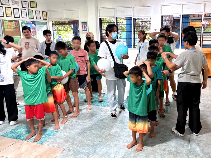 Community outreach programs by Open Access featuring volunteers engaging children in interactive activities and games during a fun-filled community outreach event.