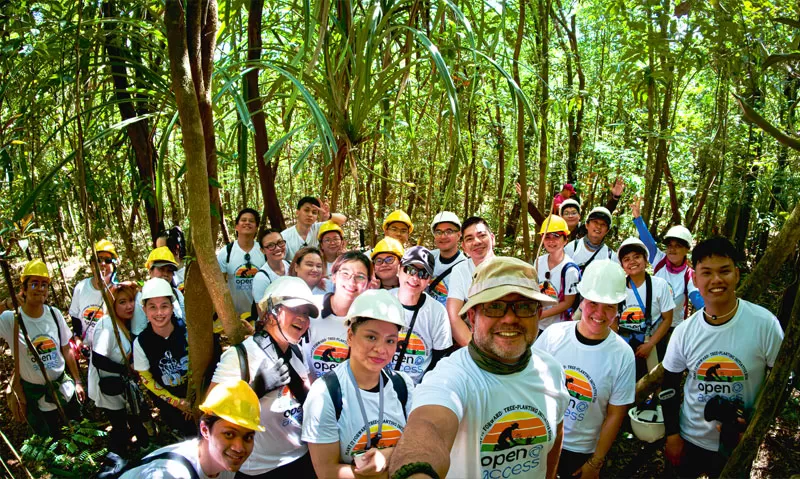 Open Access employee volunteers take a selfie inside the Sierra Madre forest during the Plant It Forward drive.