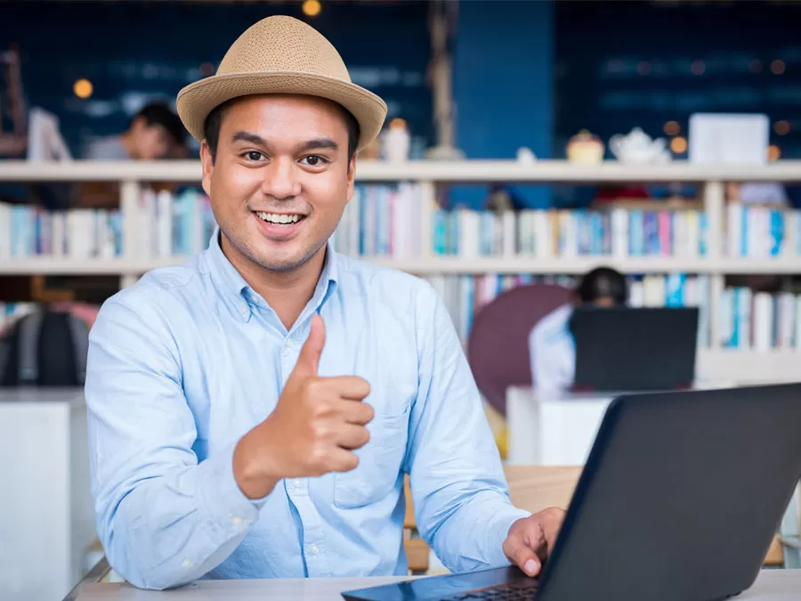 content moderation expert giving thumbs up using laptop