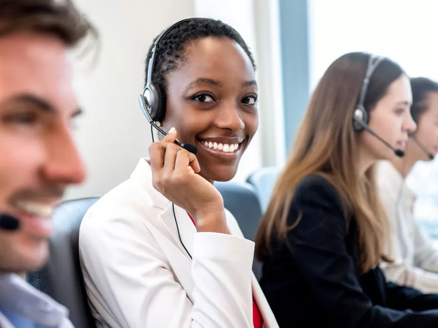 smiling customer experience expert working in customer support call center 